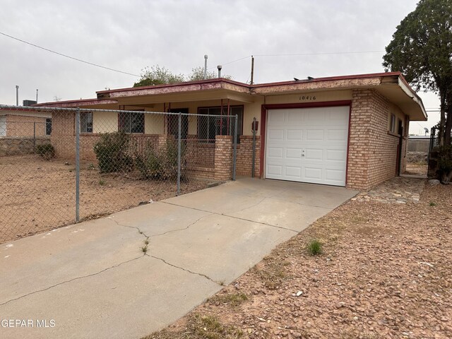 10416 Triumph Dr, El Paso, TX 79924 - ranch-style house with brick siding, a garage, and driveway