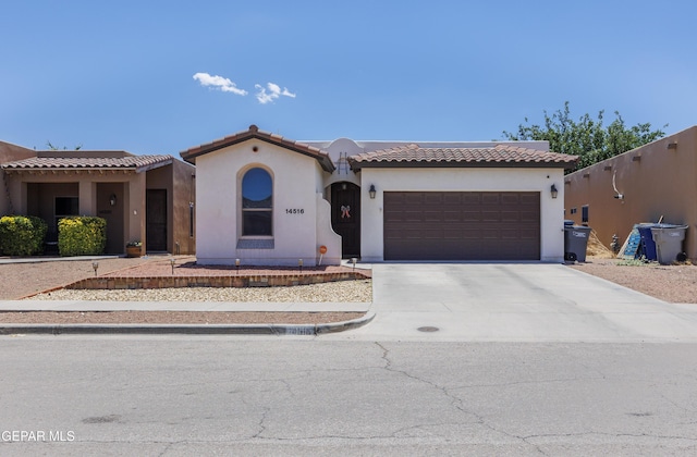 14516 Jesus Almeida, El Paso, TX 79938 - mediterranean / spanish-style house featuring a garage, stucco siding, concrete driveway, and a tiled roof