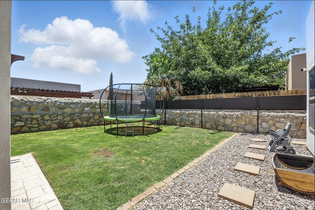 14516 Jesus Almeida, El Paso, TX 79938 - fenced backyard featuring a trampoline