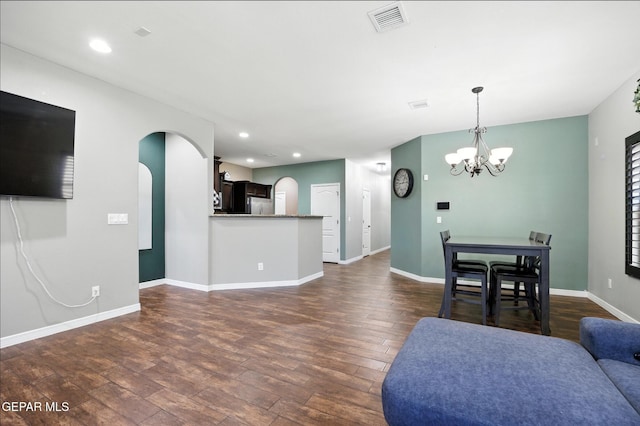 14516 Jesus Almeida, El Paso, TX 79938 - living room with arched walkways, dark wood-style flooring, a chandelier, and recessed lighting