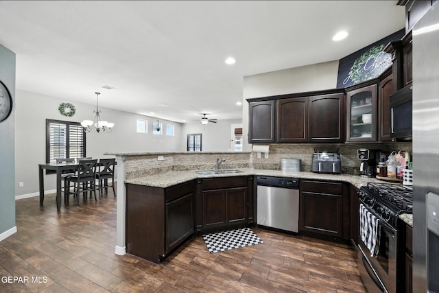 14516 Jesus Almeida, El Paso, TX 79938 - kitchen featuring stainless steel dishwasher, gas range oven, black microwave, dark brown cabinets, and a peninsula