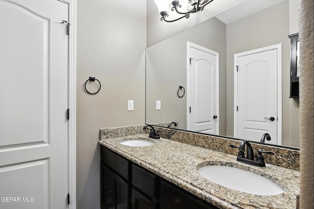 14516 Jesus Almeida, El Paso, TX 79938 - bathroom featuring double vanity and a textured wall