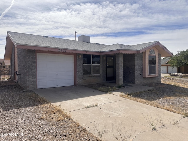 10900 Joe Dimaggio Cir, El Paso, TX 79934 - ranch-style house with a garage, brick siding, and concrete driveway