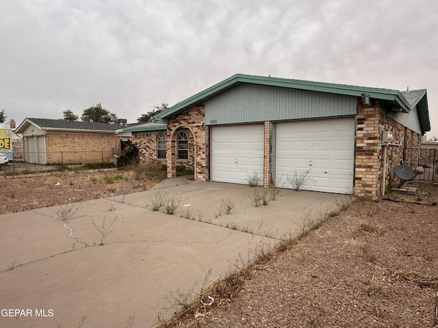 10428 Cronus Dr, El Paso, TX 79924 - view of front facade featuring concrete driveway, a garage, and brick siding