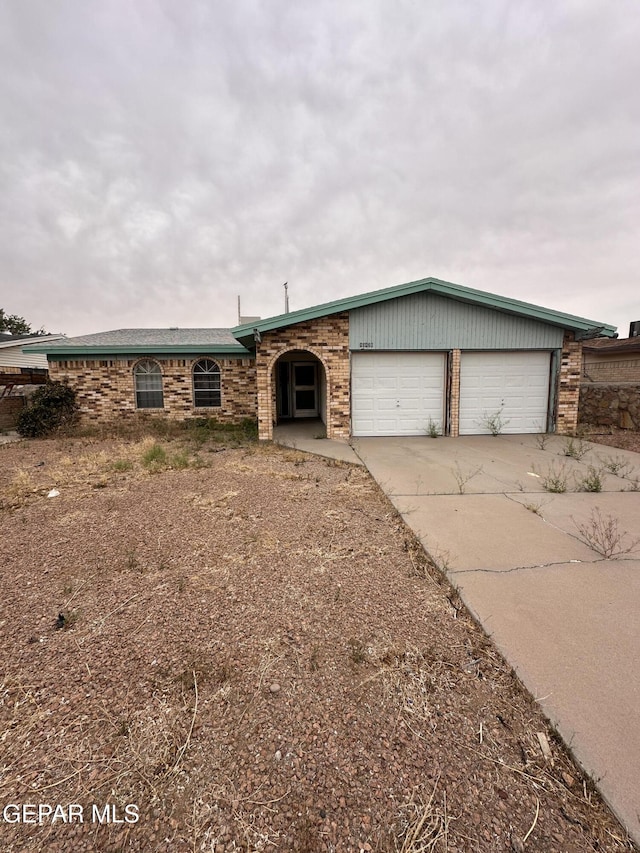 10428 Cronus Dr, El Paso, TX 79924 - view of front of home featuring driveway, an attached garage, and brick siding
