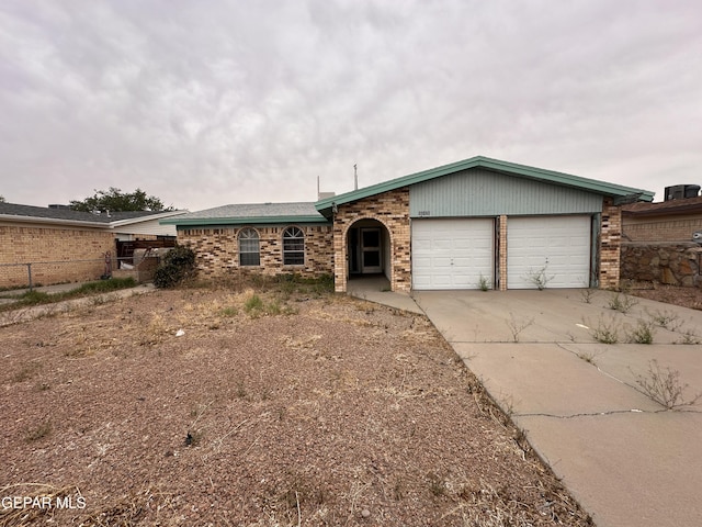 10428 Cronus Dr, El Paso, TX 79924 - view of front facade featuring a garage, concrete driveway, and brick siding