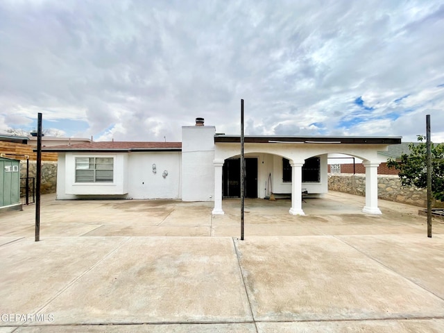 1611 James Chisum Dr, El Paso, TX 79936 - rear view of house featuring a chimney, stucco siding, and a patio area