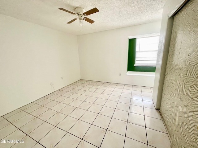 1611 James Chisum Dr, El Paso, TX 79936 - empty room featuring a ceiling fan, light tile patterned floors, and a textured ceiling
