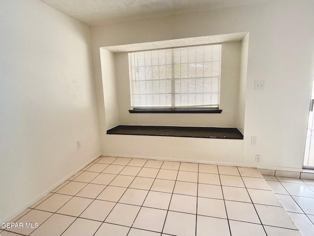 1611 James Chisum Dr, El Paso, TX 79936 - spare room with healthy amount of natural light, light tile patterned flooring, and a textured ceiling