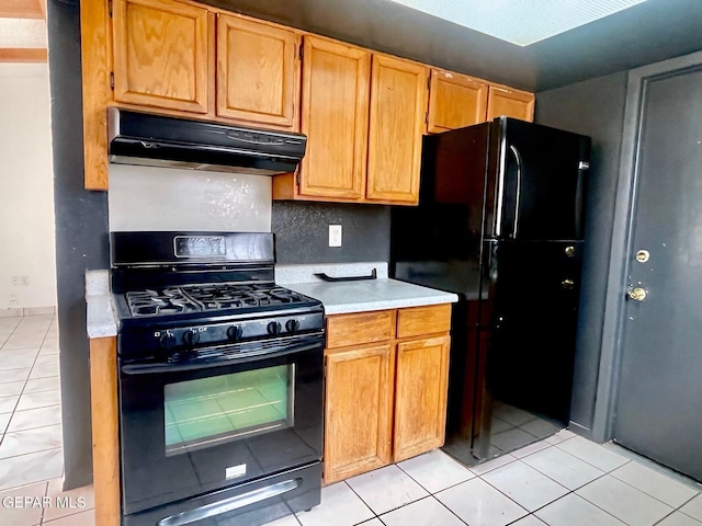 1611 James Chisum Dr, El Paso, TX 79936 - kitchen featuring black appliances, under cabinet range hood, light tile patterned flooring, and light countertops