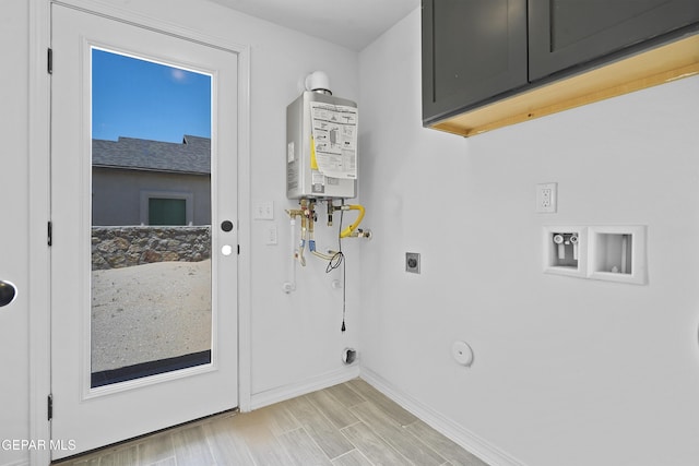 2301 Tony Harper St, El Paso, TX 79938 - laundry room featuring gas dryer hookup, electric dryer hookup, cabinet space, tankless water heater, and washer hookup