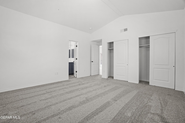 2301 Tony Harper St, El Paso, TX 79938 - unfurnished bedroom featuring multiple closets, lofted ceiling, carpet floors, and connected bathroom