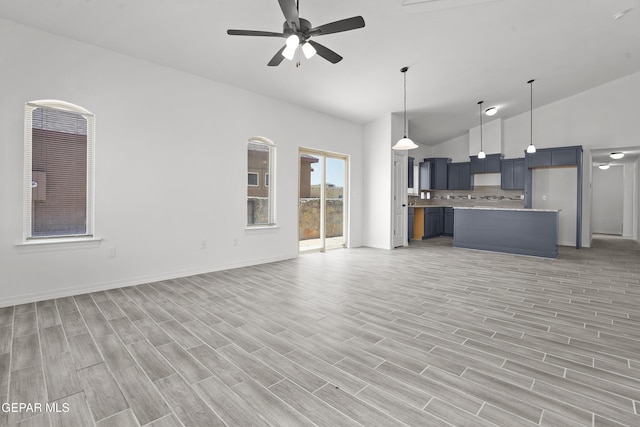 2301 Tony Harper St, El Paso, TX 79938 - kitchen with open floor plan, a ceiling fan, light countertops, hanging light fixtures, and high vaulted ceiling