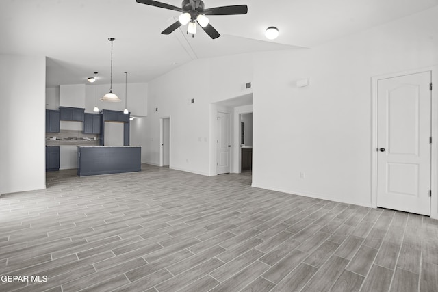 2301 Tony Harper St, El Paso, TX 79938 - unfurnished living room featuring a ceiling fan, light wood-style floors, and high vaulted ceiling
