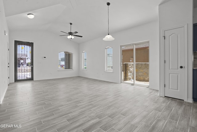 2301 Tony Harper St, El Paso, TX 79938 - unfurnished living room featuring ceiling fan, vaulted ceiling, and light wood-style flooring