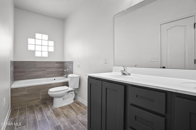 2301 Tony Harper St, El Paso, TX 79938 - full bath with double vanity, a garden tub, and wood finished floors