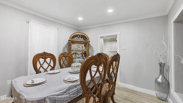 2123 Magoffin Ave, El Paso, TX 79901 - dining space with light wood finished floors, crown molding, and recessed lighting