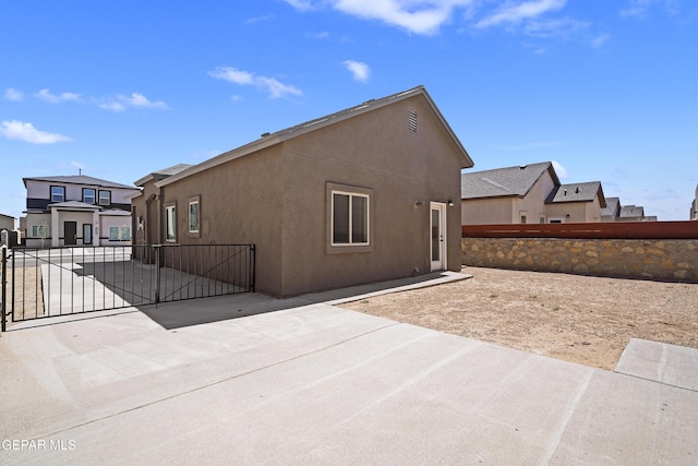 14325 Toby Davis Dr, Horizon City, TX 79928 - back of property featuring a gate, a patio, and stucco siding