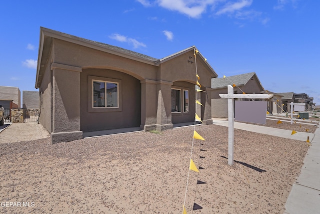 14325 Toby Davis Dr, Horizon City, TX 79928 - view of front facade with stucco siding and a gate