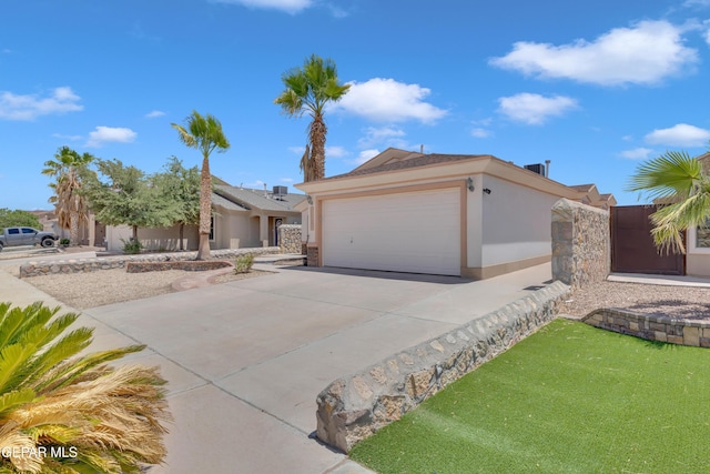 14304 Woods Point Ave, El Paso, TX 79938 - single story home featuring stucco siding, driveway, and an attached garage