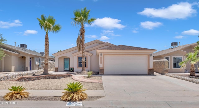 14304 Woods Point Ave, El Paso, TX 79938 - view of front of property featuring a garage, concrete driveway, and stucco siding