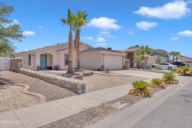 14304 Woods Point Ave, El Paso, TX 79938 - mediterranean / spanish-style house featuring an attached garage, stucco siding, driveway, and a gate