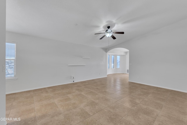 14304 Woods Point Ave, El Paso, TX 79938 - empty room featuring a ceiling fan, arched walkways, and light tile patterned flooring
