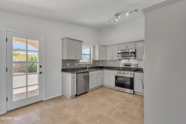 14304 Woods Point Ave, El Paso, TX 79938 - kitchen featuring stainless steel appliances, tasteful backsplash, dark stone countertops, and light tile patterned floors