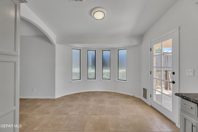 14304 Woods Point Ave, El Paso, TX 79938 - spare room with light tile patterned floors and arched walkways