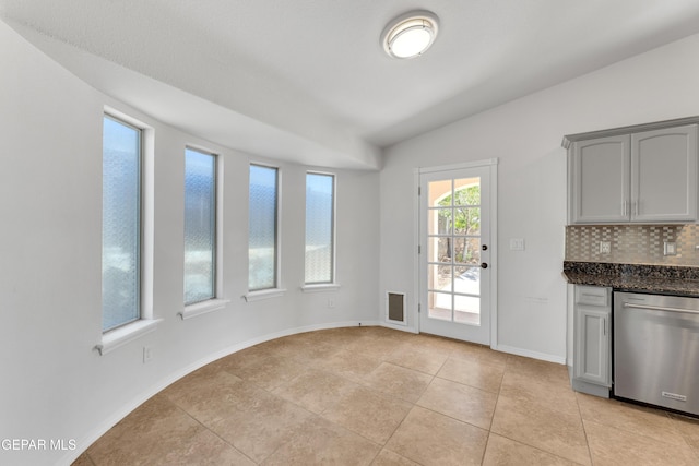 14304 Woods Point Ave, El Paso, TX 79938 - unfurnished dining area with light tile patterned flooring and vaulted ceiling