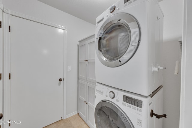 14304 Woods Point Ave, El Paso, TX 79938 - laundry room with stacked washer / dryer and cabinet space