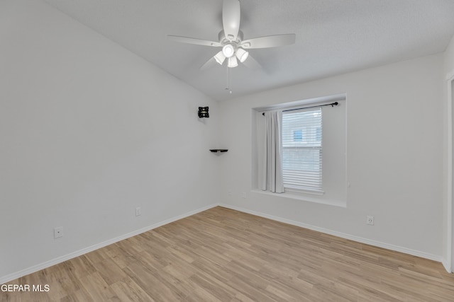 14304 Woods Point Ave, El Paso, TX 79938 - spare room featuring light wood-style flooring, a ceiling fan, and lofted ceiling
