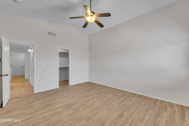 14304 Woods Point Ave, El Paso, TX 79938 - unfurnished bedroom featuring light wood-style flooring, lofted ceiling, a spacious closet, a closet, and ceiling fan