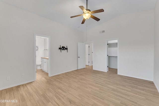 14304 Woods Point Ave, El Paso, TX 79938 - unfurnished bedroom featuring high vaulted ceiling, light wood-type flooring, a spacious closet, connected bathroom, and a closet