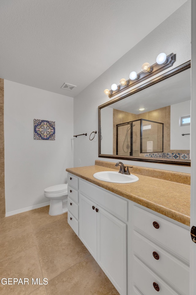14304 Woods Point Ave, El Paso, TX 79938 - bathroom featuring vanity, a shower with door, tile patterned flooring, and a textured ceiling