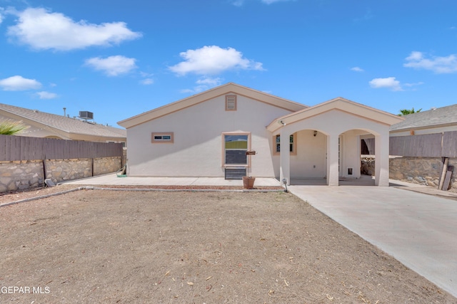 14304 Woods Point Ave, El Paso, TX 79938 - rear view of house with stucco siding and a patio area