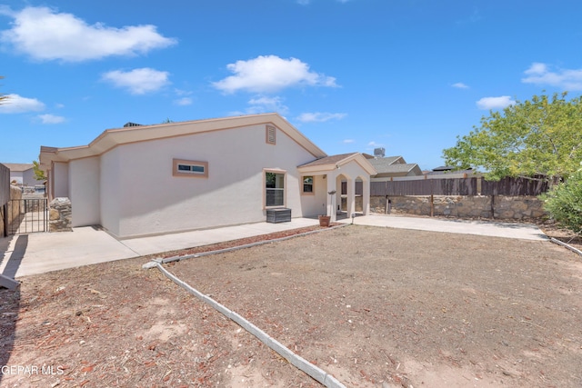 14304 Woods Point Ave, El Paso, TX 79938 - back of house with stucco siding, a patio area, and a gate