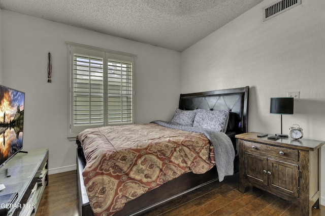 12372 Robert Dahl Dr, El Paso, TX 79938 - bedroom featuring dark wood-style floors and a textured ceiling