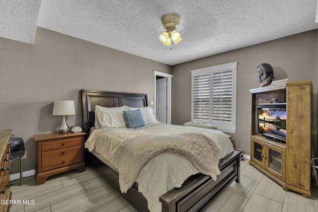 12372 Robert Dahl Dr, El Paso, TX 79938 - bedroom featuring a textured ceiling and baseboards