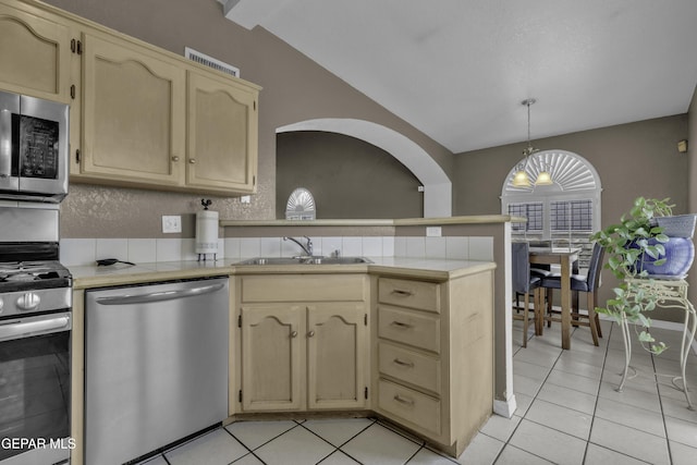 12372 Robert Dahl Dr, El Paso, TX 79938 - kitchen featuring appliances with stainless steel finishes, a peninsula, vaulted ceiling, light tile patterned floors, and tile countertops