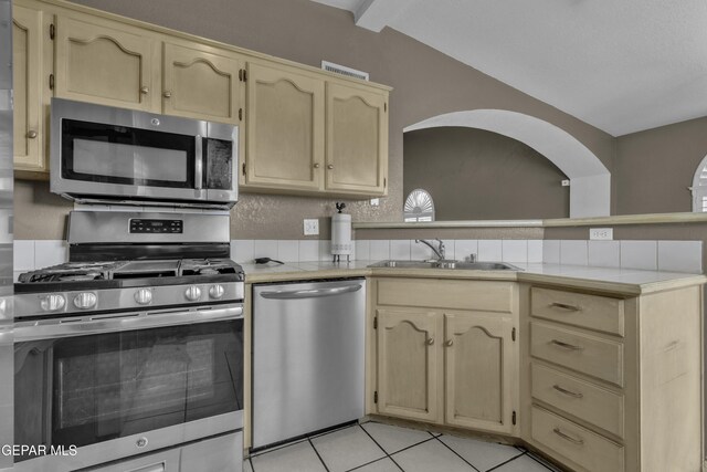 12372 Robert Dahl Dr, El Paso, TX 79938 - kitchen featuring stainless steel appliances, a peninsula, tile counters, light tile patterned floors, and light brown cabinetry