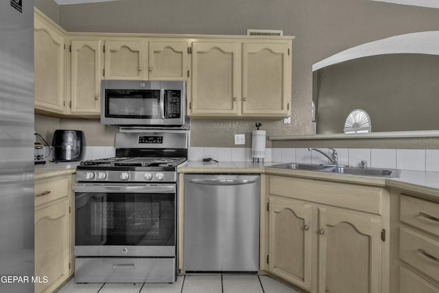 12372 Robert Dahl Dr, El Paso, TX 79938 - kitchen featuring stainless steel appliances, light tile patterned flooring, light brown cabinetry, and tile counters