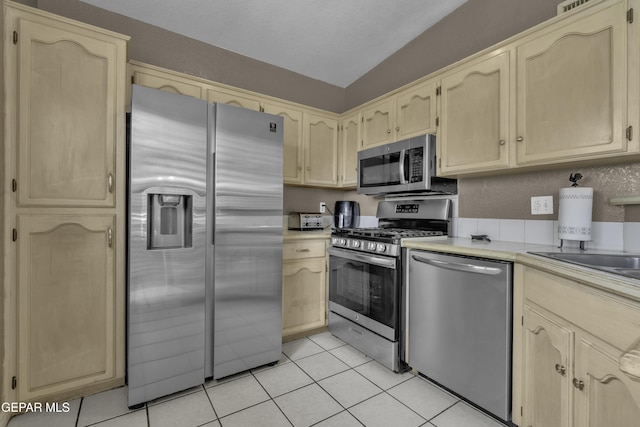 12372 Robert Dahl Dr, El Paso, TX 79938 - kitchen with appliances with stainless steel finishes, light brown cabinets, light tile patterned floors, and light countertops