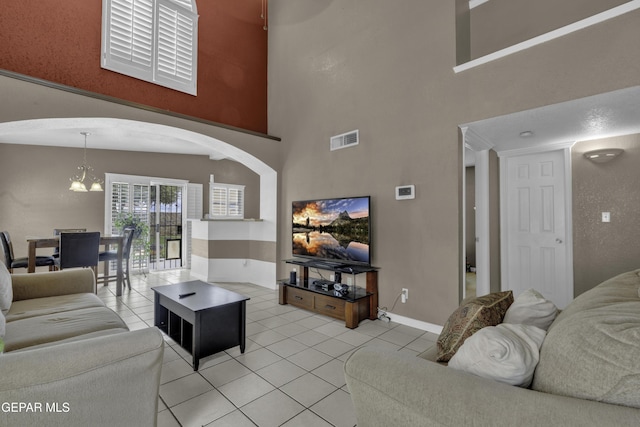 12372 Robert Dahl Dr, El Paso, TX 79938 - living room featuring light tile patterned flooring, a chandelier, and a high ceiling