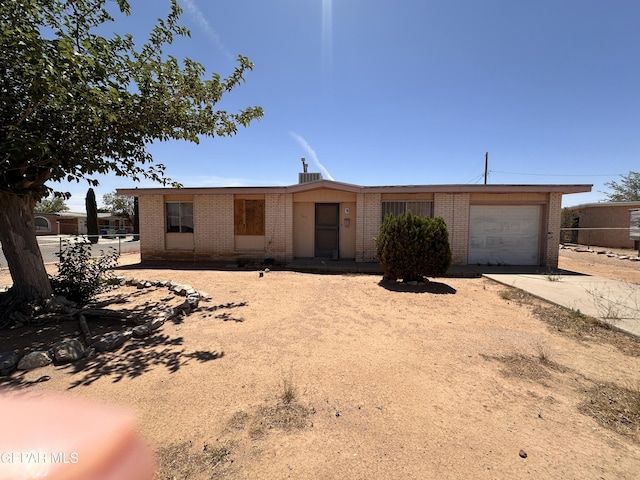10452 Omega Cir, El Paso, TX 79924 - view of front facade featuring brick siding, a garage, and driveway
