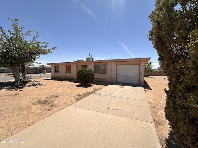 10452 Omega Cir, El Paso, TX 79924 - view of front facade featuring brick siding, concrete driveway, and an attached garage