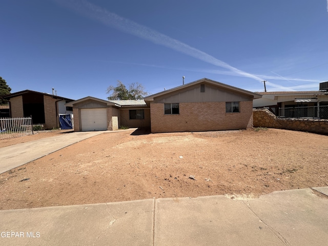 5513 Fairbanks Dr, El Paso, TX 79924 - view of front of home featuring brick siding, concrete driveway, and an attached garage