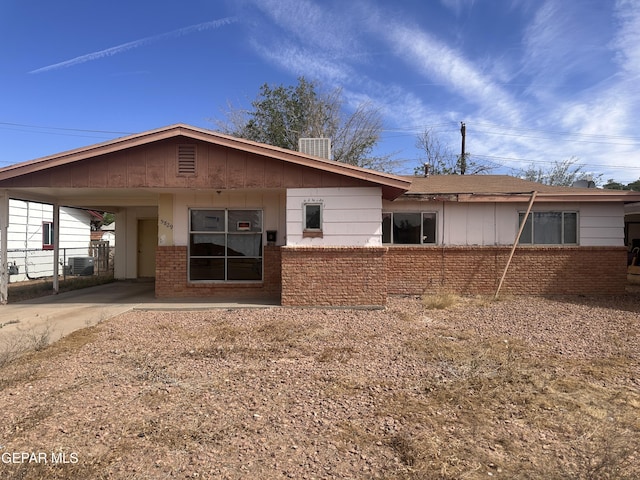 5829 Nike Ln, El Paso, TX 79924 - back of property with brick siding, a carport, and concrete driveway