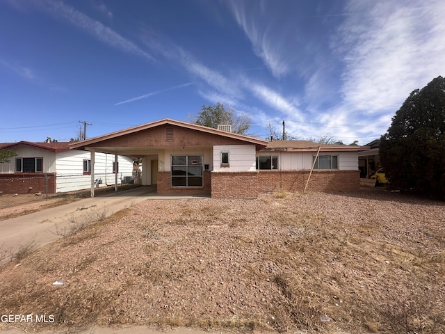 5829 Nike Ln, El Paso, TX 79924 - view of front of house with brick siding, driveway, and an attached carport