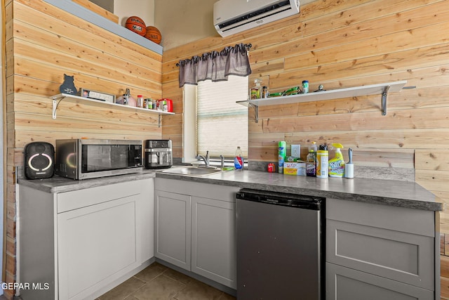1624 Vinton Rd, Anthony, NM 88021 - kitchen with open shelves, a wall unit AC, stainless steel microwave, wood walls, and dishwashing machine